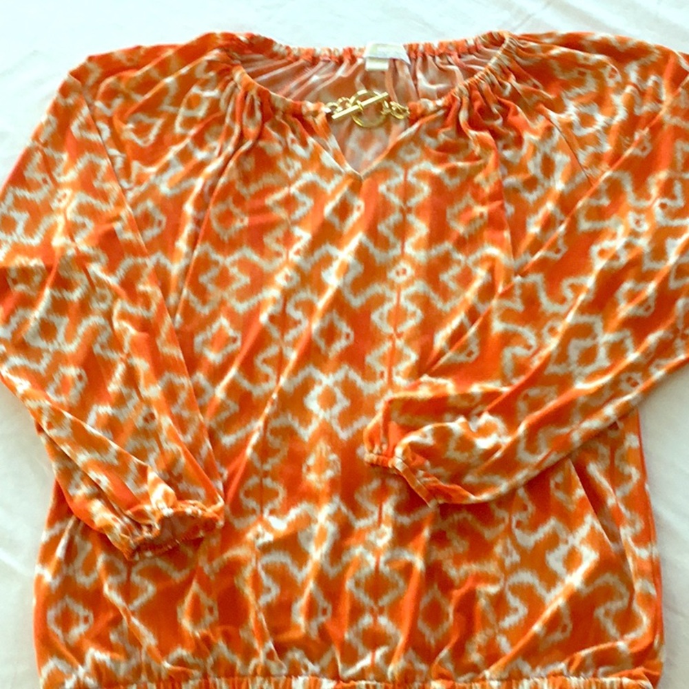 Michael Kors stylish orange and white blouse.